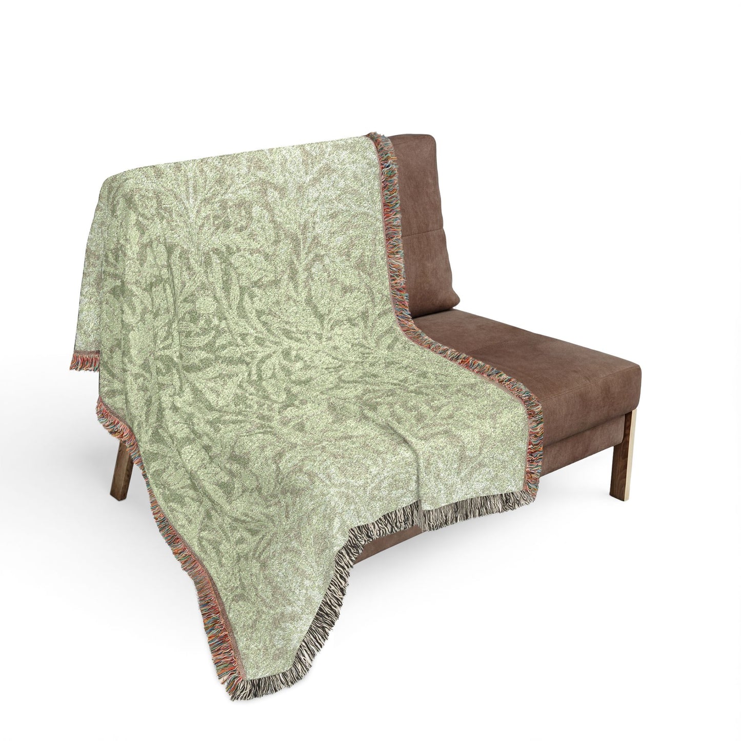 Patterned blanket draped over a brown chair on a white background
