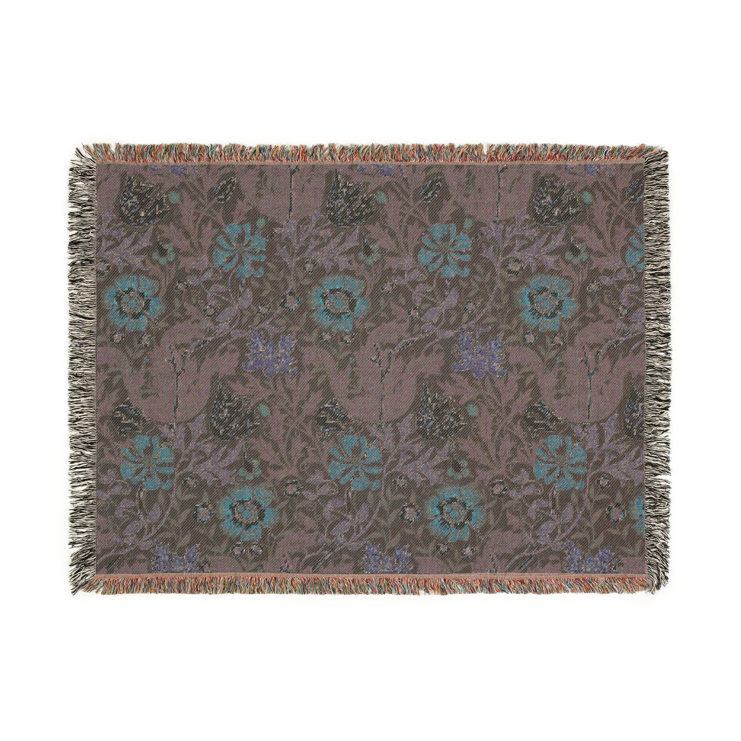A woven cotton blanket with a William Morris & Co floral pattern in green, brown, and beige colours, featuring colourful fringed edges.