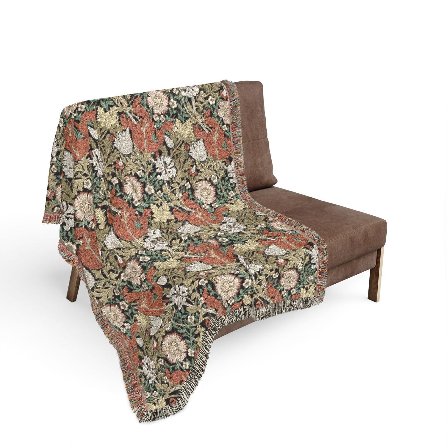 Floral patterned throw blanket draped over a brown chair on a white background