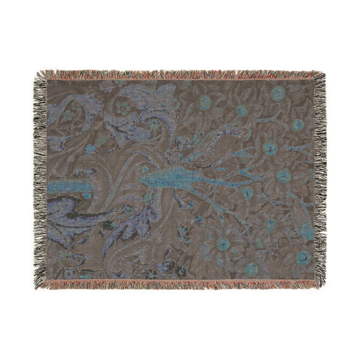 A woven cotton blanket with a William Morris & Co floral and bird pattern, featuring a colourful fringe.