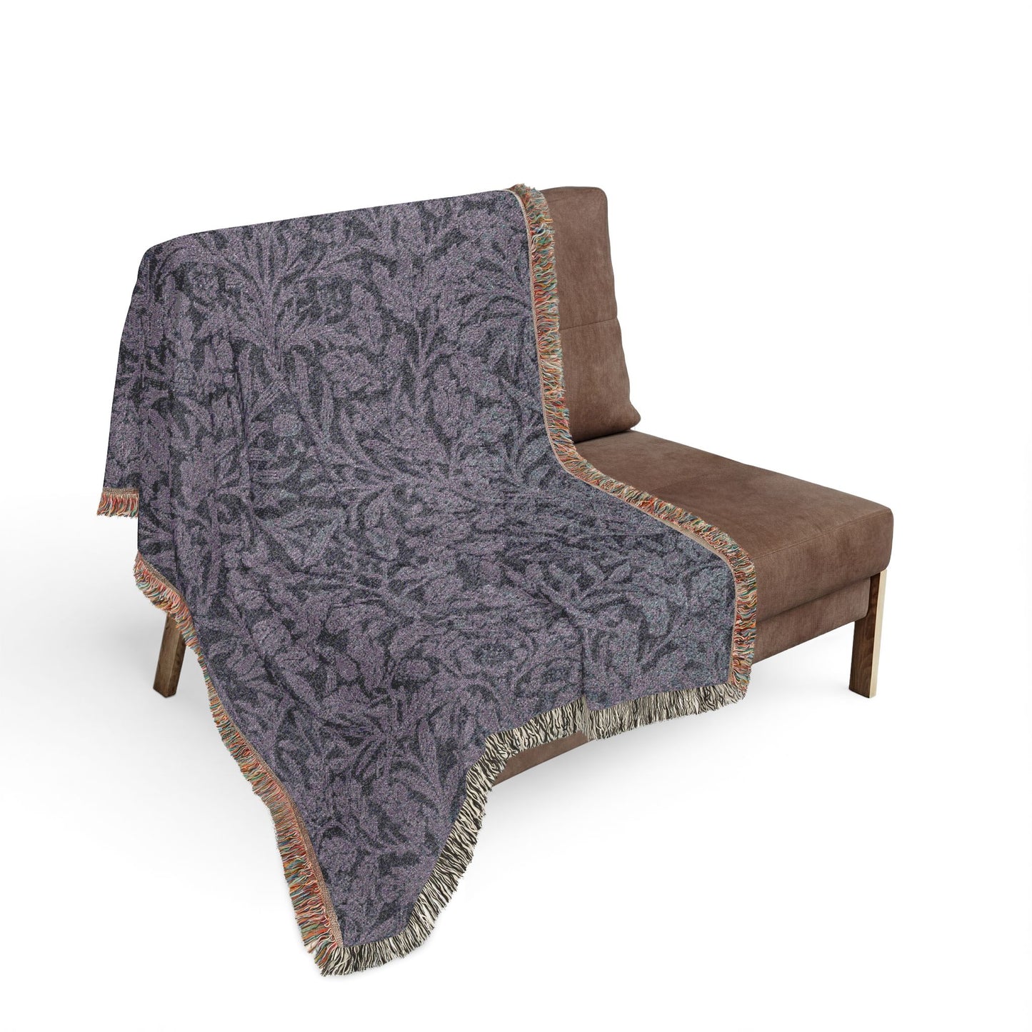 Gray patterned throw blanket draped over a brown chair on a white background