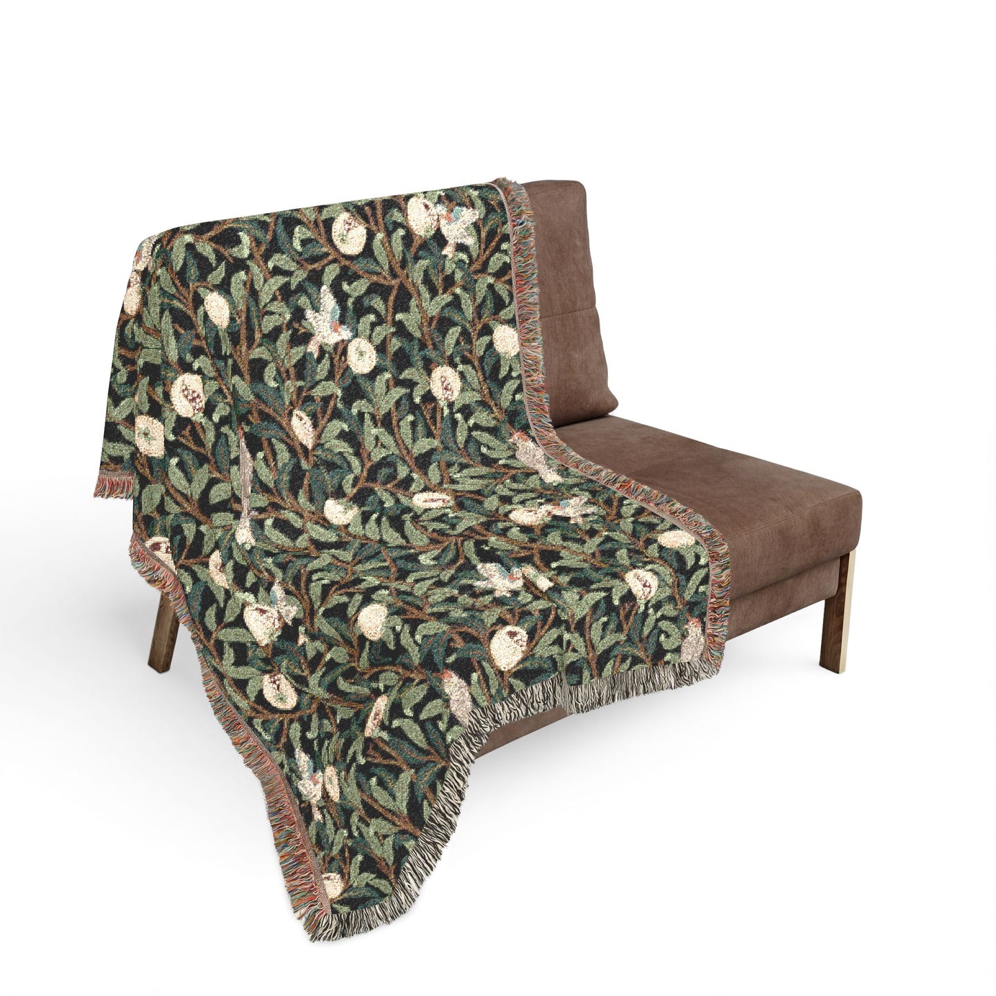 Green patterned blanket draped over a brown chair on a white background