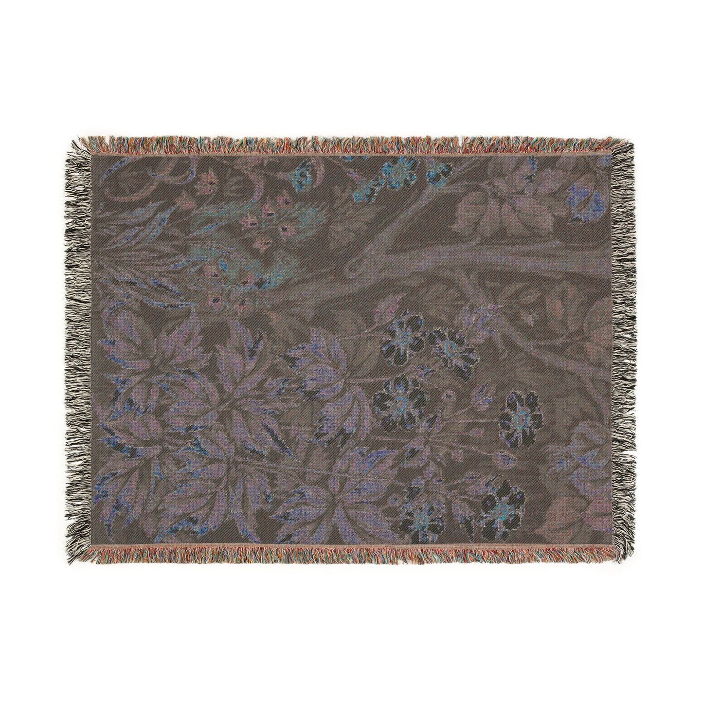 A woven cotton blanket with a nature-inspired geometric pattern featuring squirrels and flowers, predominantly in green and brown tones, with a colourful fringed edge.