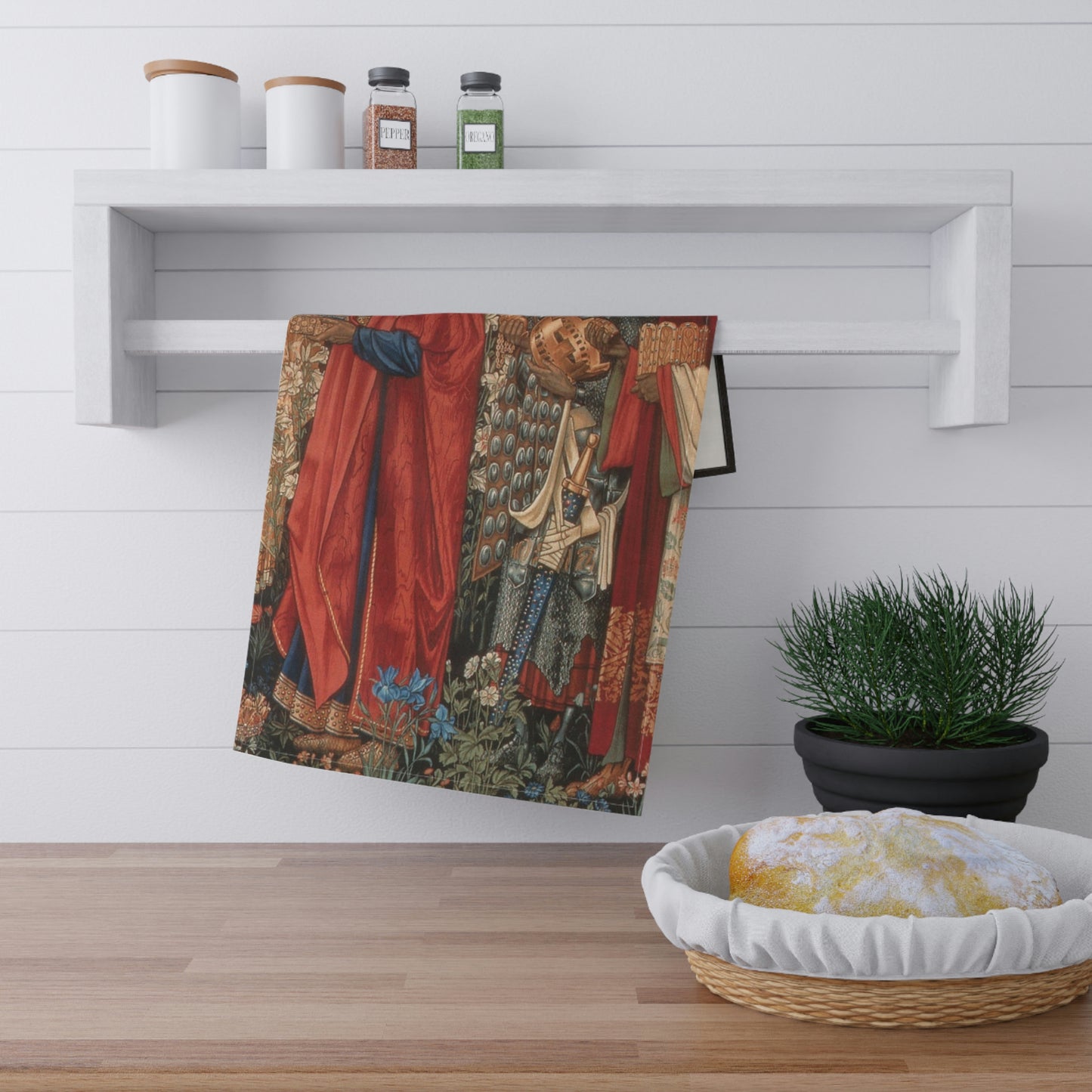 A kitchen tea towel featuring a historical or religious artwork with multiple characters in vibrant colours.