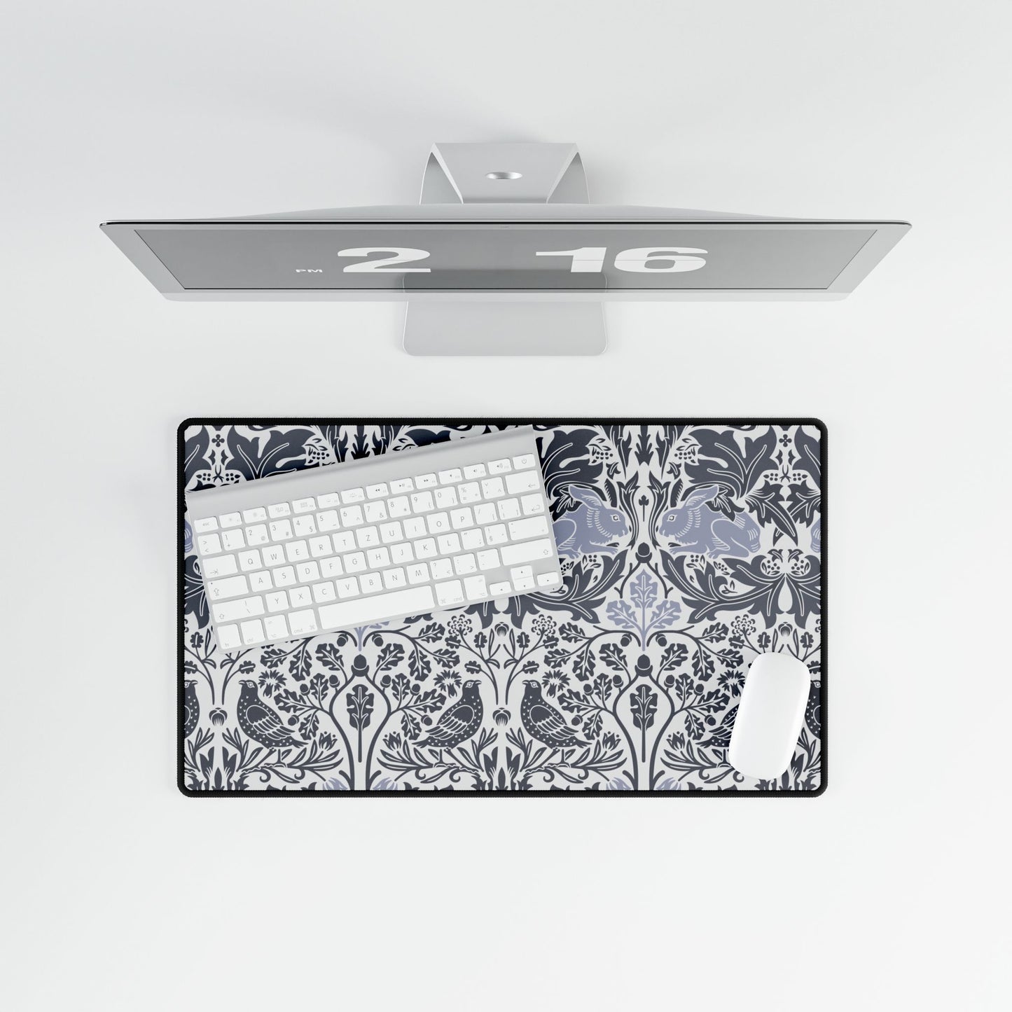Floral patterned desk mat with a computer setup on a white background