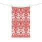 A rectangular tea towel with a red and white ornate floral damask pattern, hanging from a string with three wooden clothespins against a plain white background.