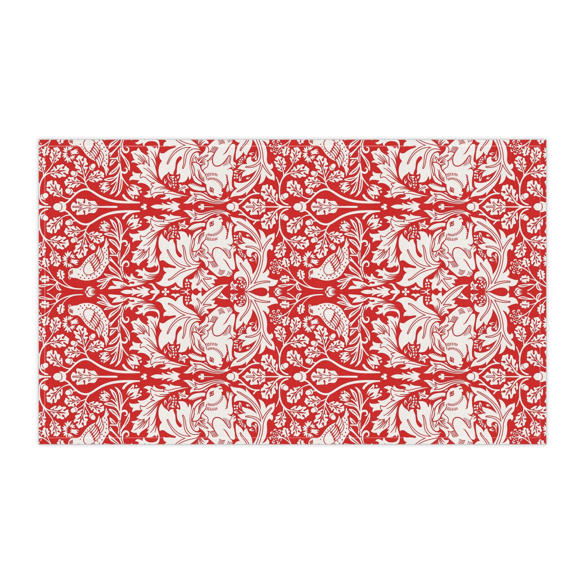 A rectangular tea towel featuring a bold red and off-white floral and botanical pattern, shown flat against a plain white background.