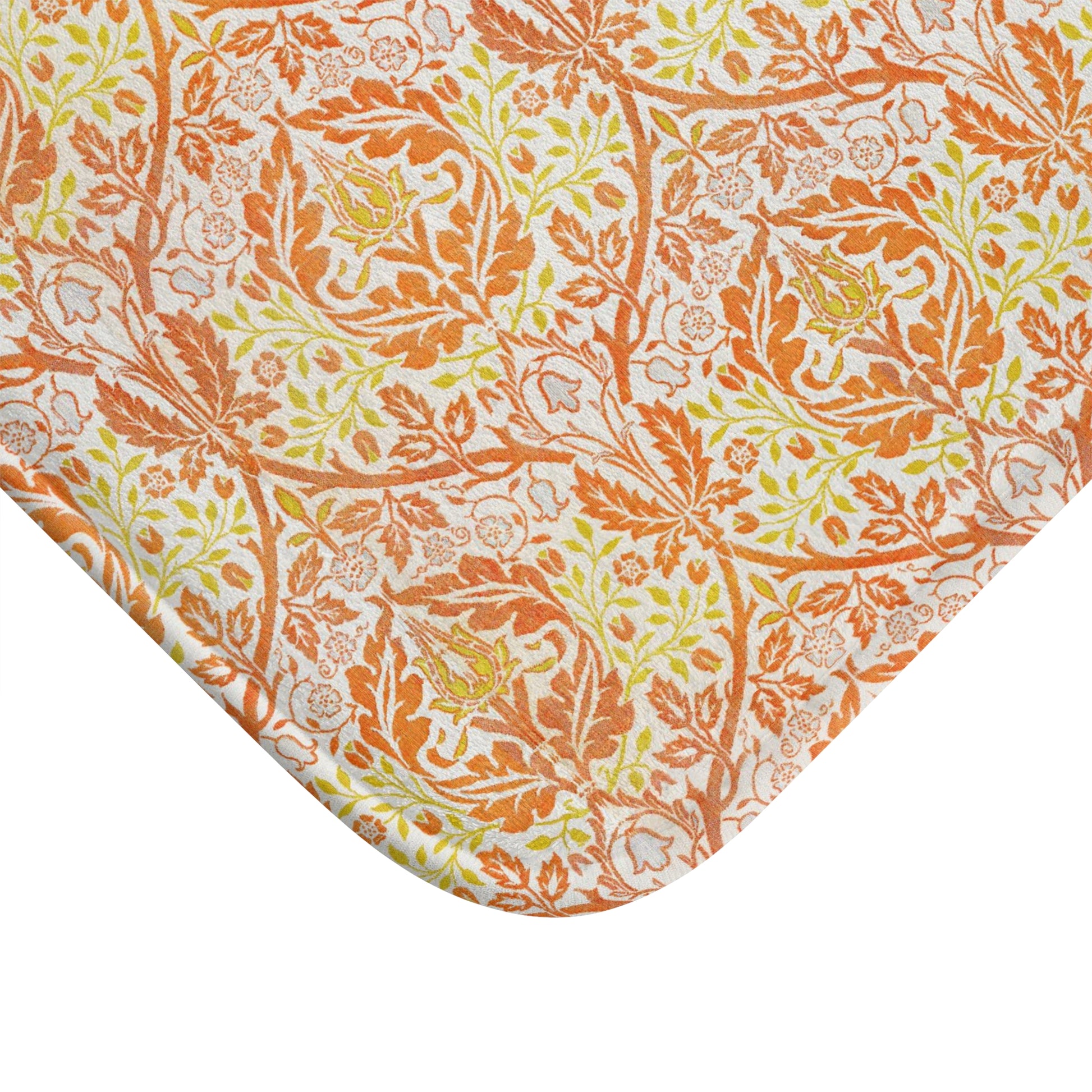 A rectangular microfibre bath mat with a floral pattern inspired by William Morris, in predominantly orange and yellow shades.