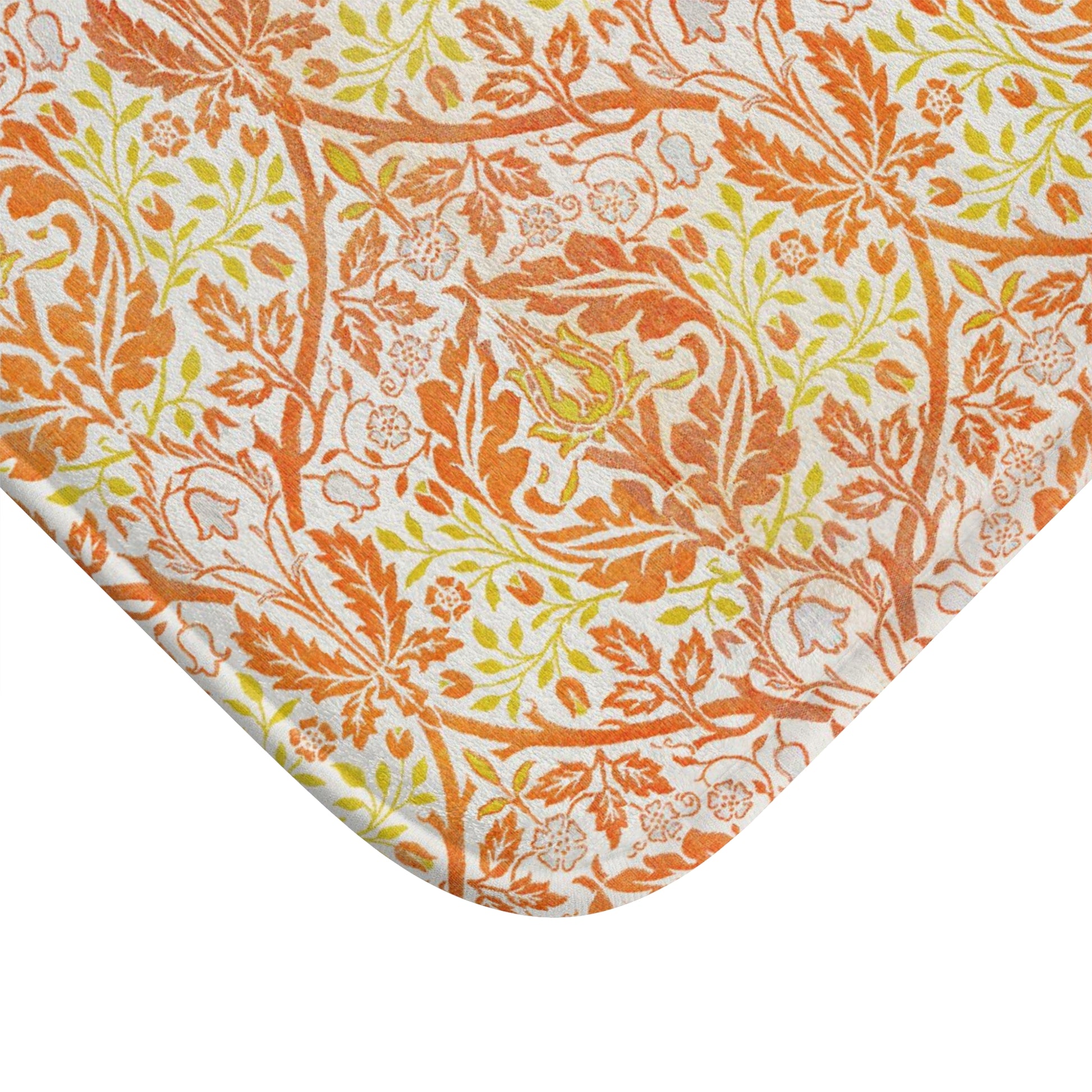 A rectangular microfibre bath mat with a floral pattern inspired by William Morris, in predominantly orange and yellow shades.