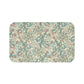 Rectangular microfibre bath mat with a floral pattern inspired by William Morris, in colors green, beige, and pink.