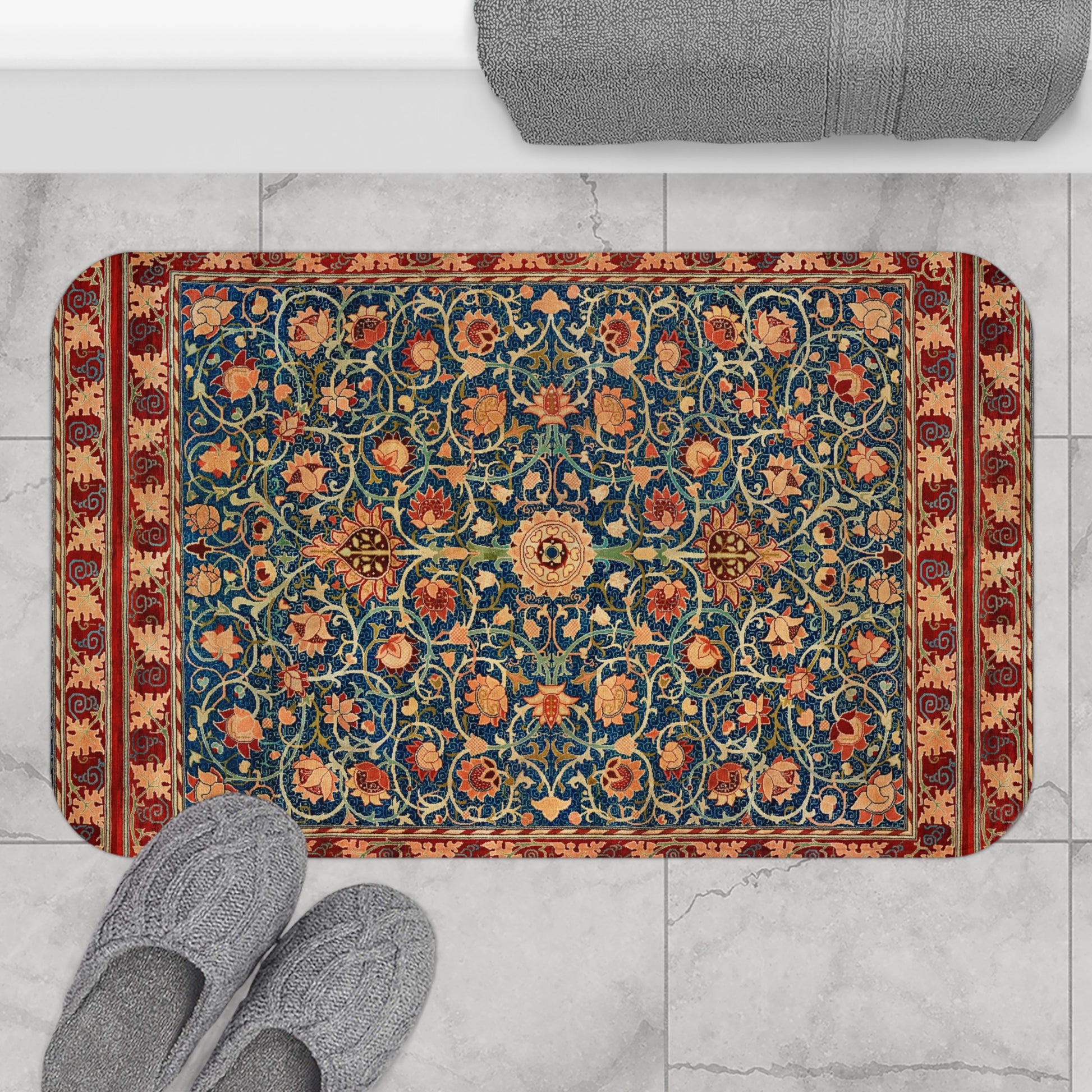 Decorative rug with floral pattern on a marble floor, with slippers and a bath mat in the foreground.