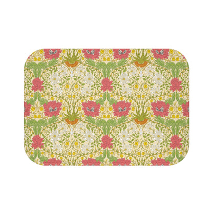 A rectangular microfibre bath mat with a floral pattern inspired by William Morris, in colours green, pink, yellow, and white.