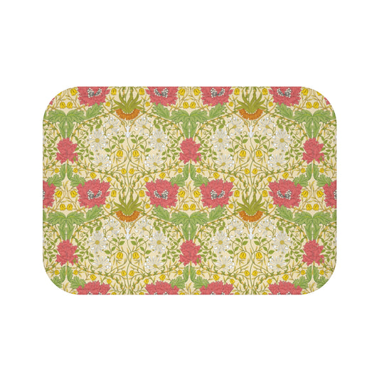 A rectangular microfibre bath mat with a floral pattern inspired by William Morris, in colours green, pink, yellow, and white.