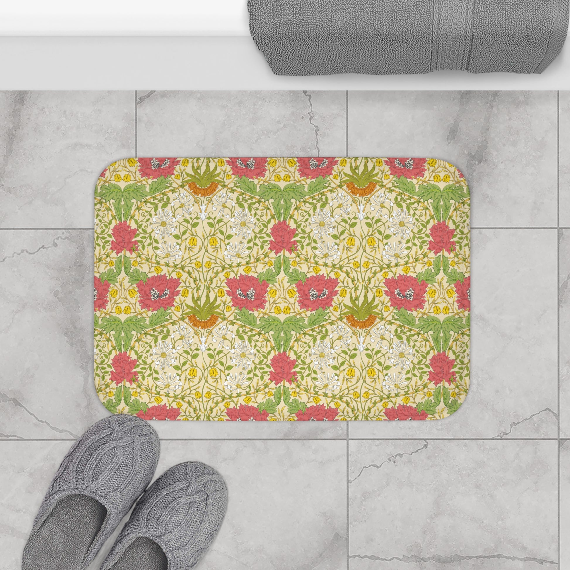 A rectangular microfibre bath mat with a floral pattern inspired by William Morris, in colours green, pink, yellow, and white.