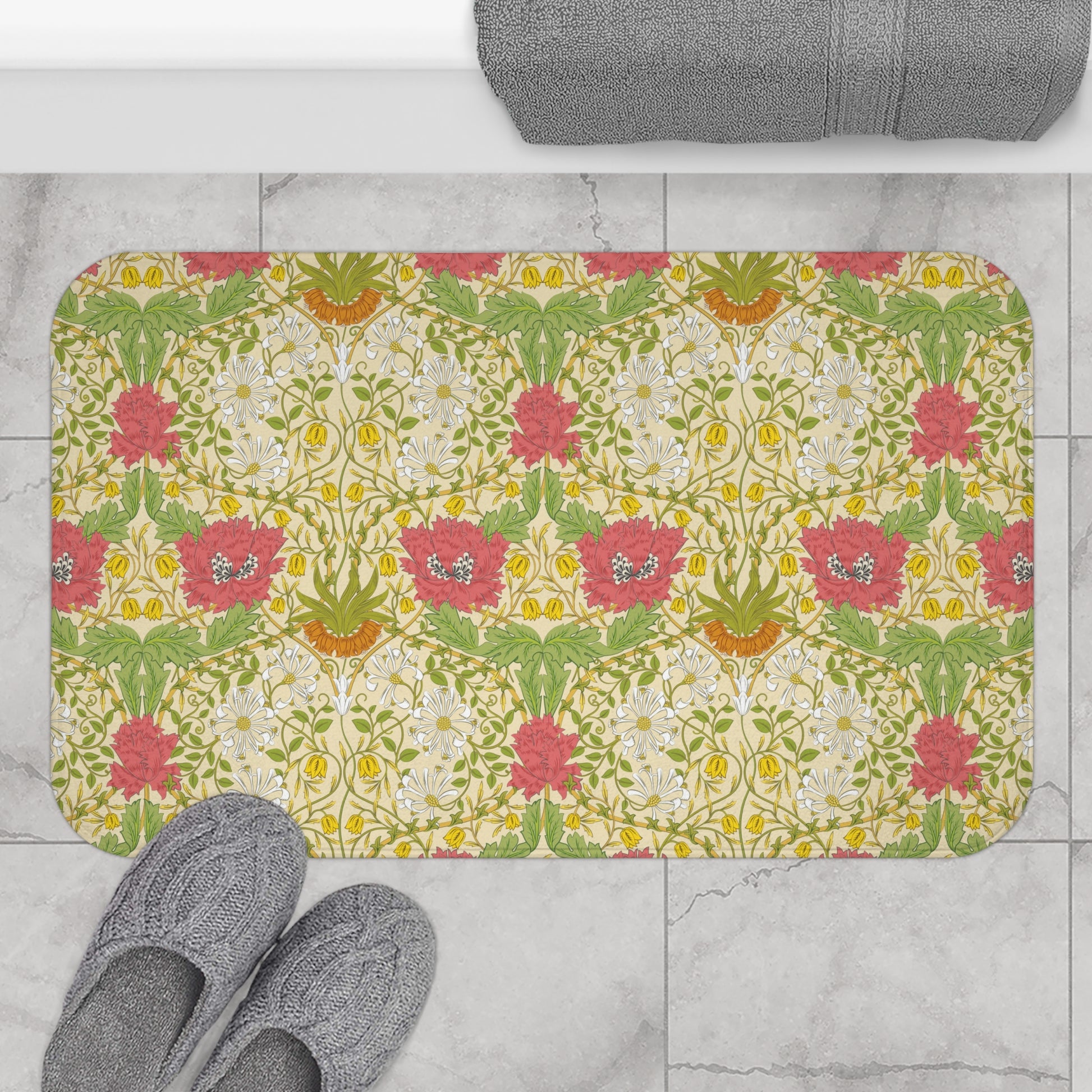 A rectangular microfibre bath mat with a floral pattern inspired by William Morris, in colours green, pink, yellow, and white.