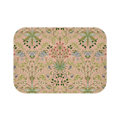 A rectangular microfibre bath mat with a floral pattern inspired by William Morris, in colors pink, green, and white.