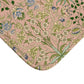 A rectangular microfibre bath mat with a floral pattern inspired by William Morris, in colours pink, green, and white.