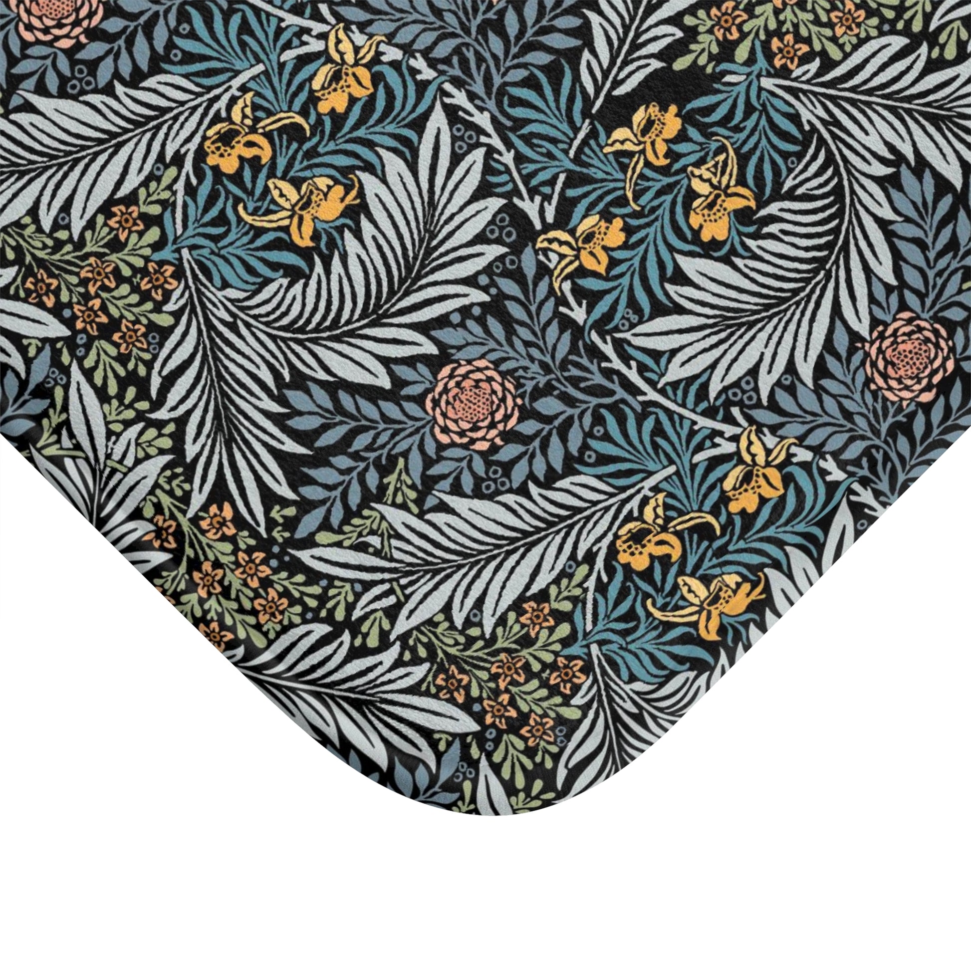 A rectangular microfibre bath mat with a blue background featuring an elegant floral pattern inspired by William Morris' work.