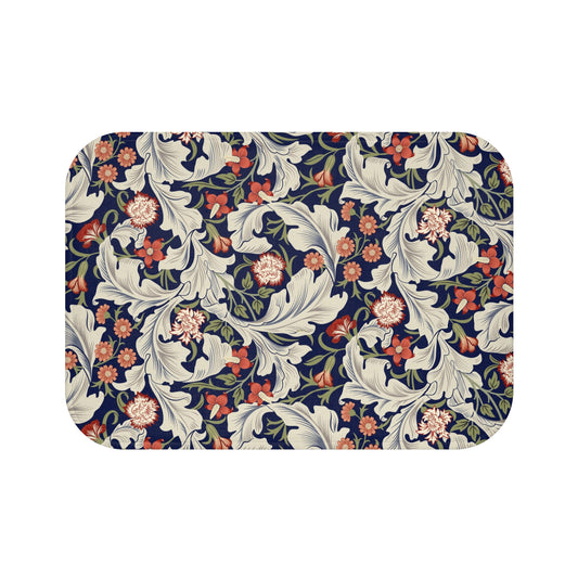 A rectangular microfibre bath mat with a floral pattern inspired by William Morris, predominantly in blue and white colours.