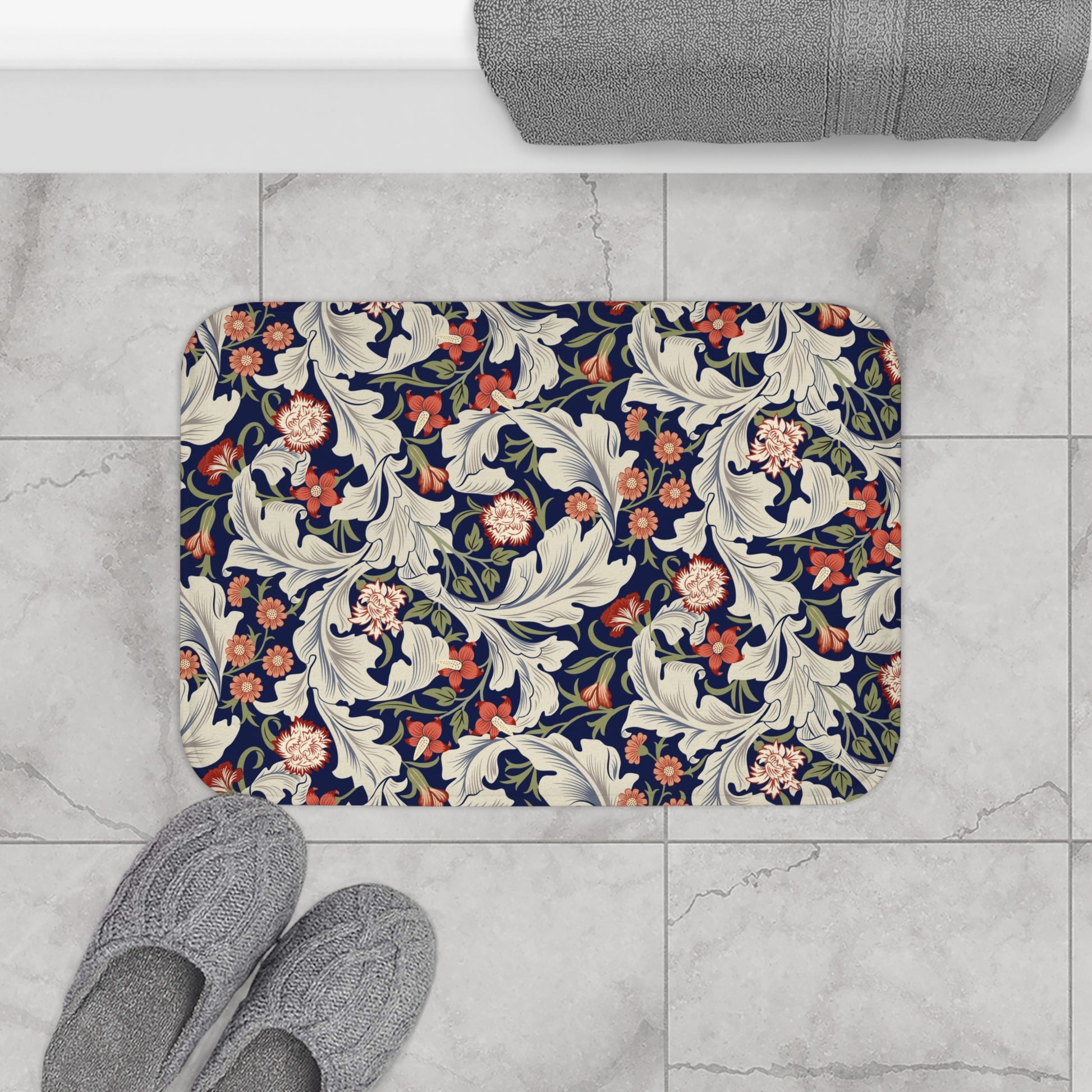 A rectangular microfibre bath mat with a floral pattern inspired by William Morris, predominantly in blue and white colours.