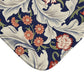 A rectangular microfibre bath mat with a floral pattern inspired by William Morris, predominantly in blue and white colours.