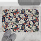 A rectangular microfibre bath mat with a floral pattern inspired by William Morris, predominantly in blue and white colours.