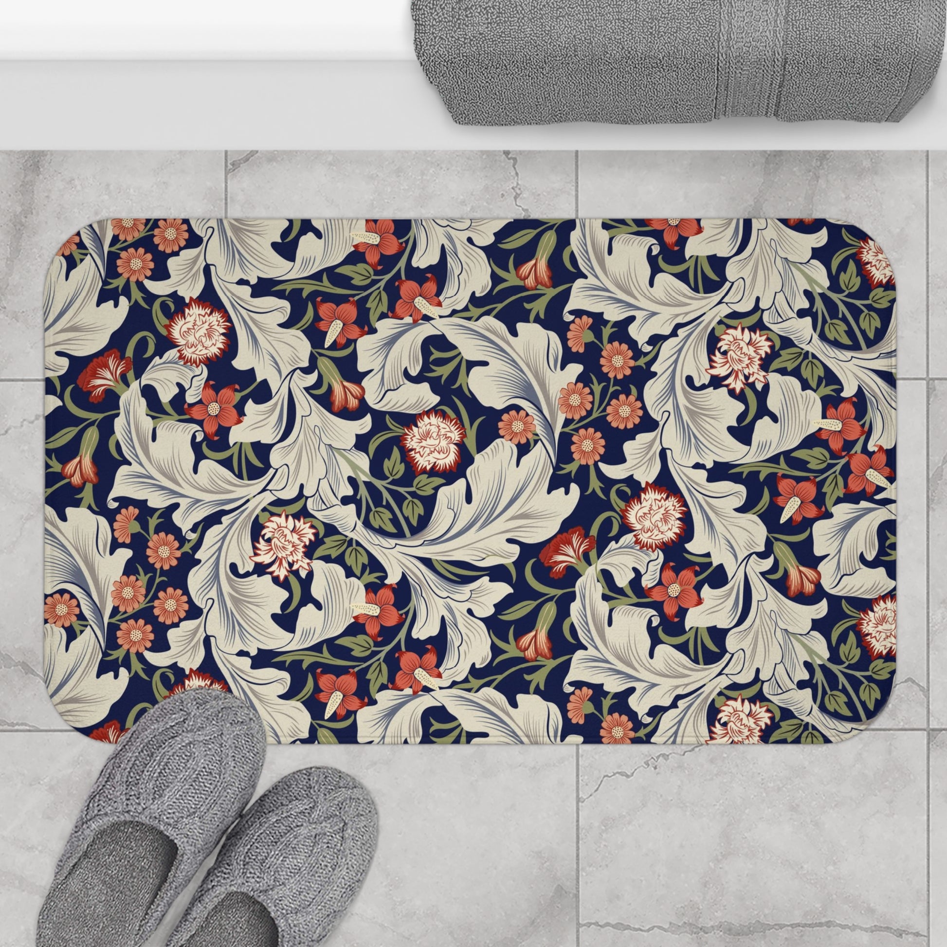 A rectangular microfibre bath mat with a floral pattern inspired by William Morris, predominantly in blue and white colours.