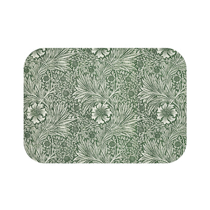 A rectangular microfibre bath mat with an all-over print of green and white floral patterns inspired by William Morris.