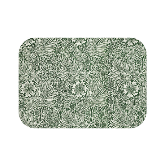 A rectangular microfibre bath mat with an all-over print of green and white floral patterns inspired by William Morris.