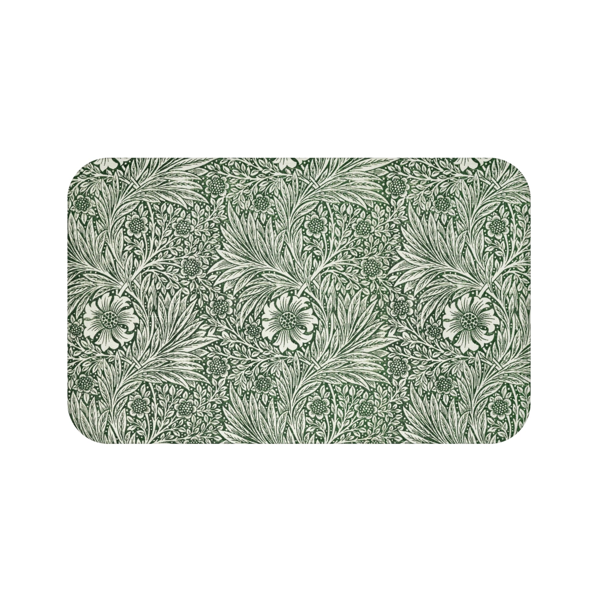 A rectangular microfibre bath mat with an all-over print of green and white floral patterns inspired by William Morris.
