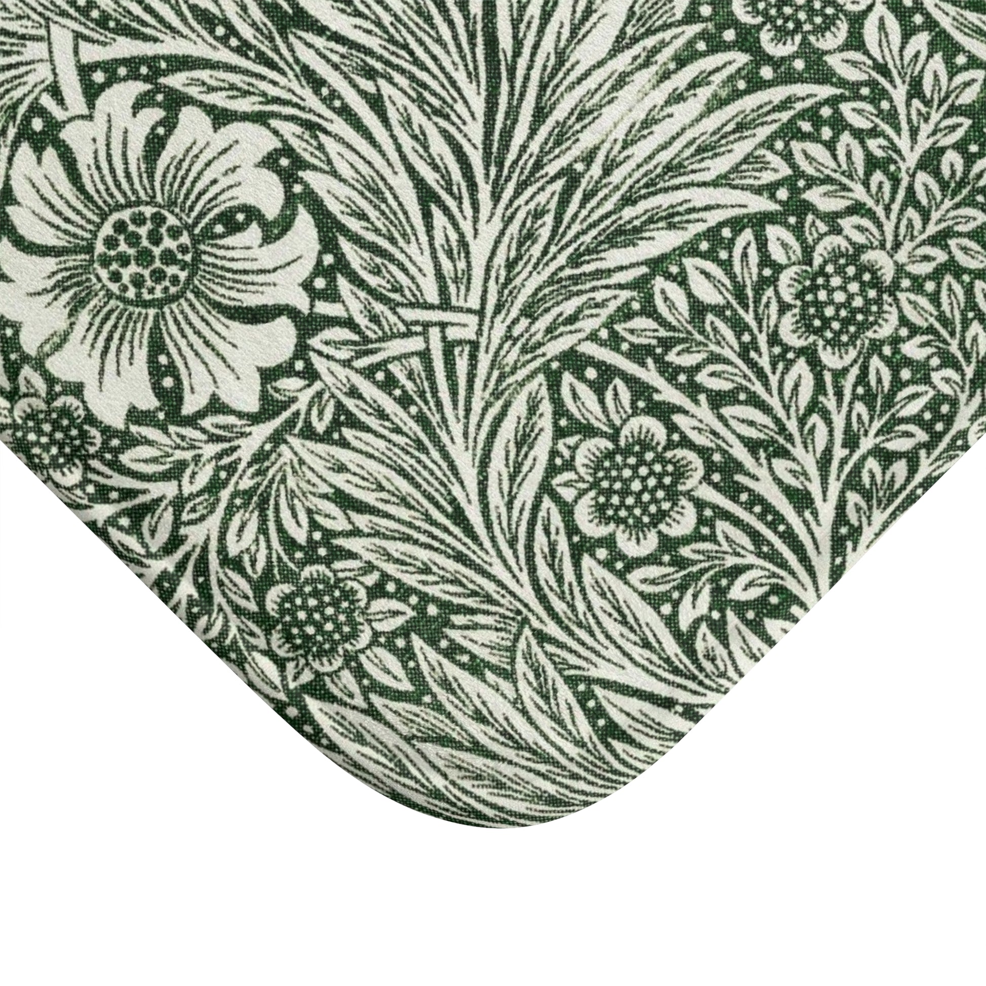 A rectangular microfibre bath mat with an all-over print of green and white floral patterns inspired by William Morris.
