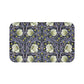 A rectangular microfibre bath mat with a floral pattern in shades of purple and green, inspired by William Morris' design.