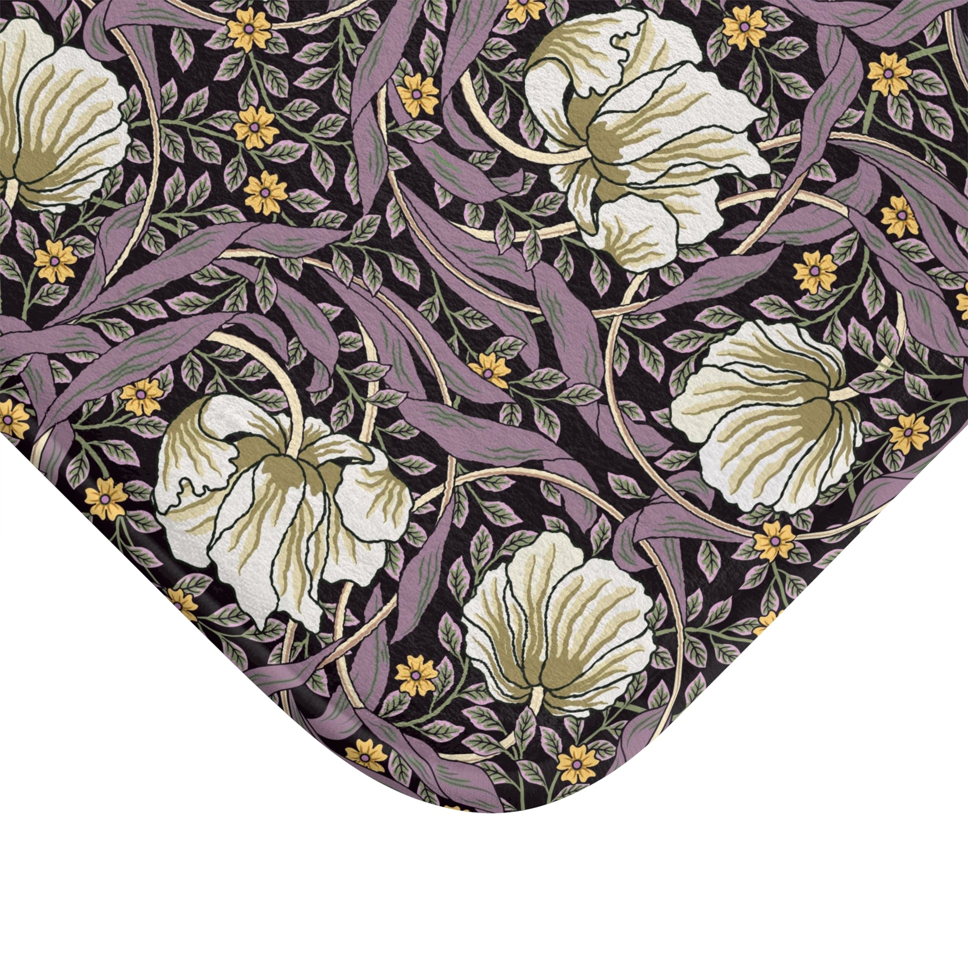 A rectangular microfibre bath mat with a floral pattern inspired by William Morris, predominantly in pink, purple and gold colours.