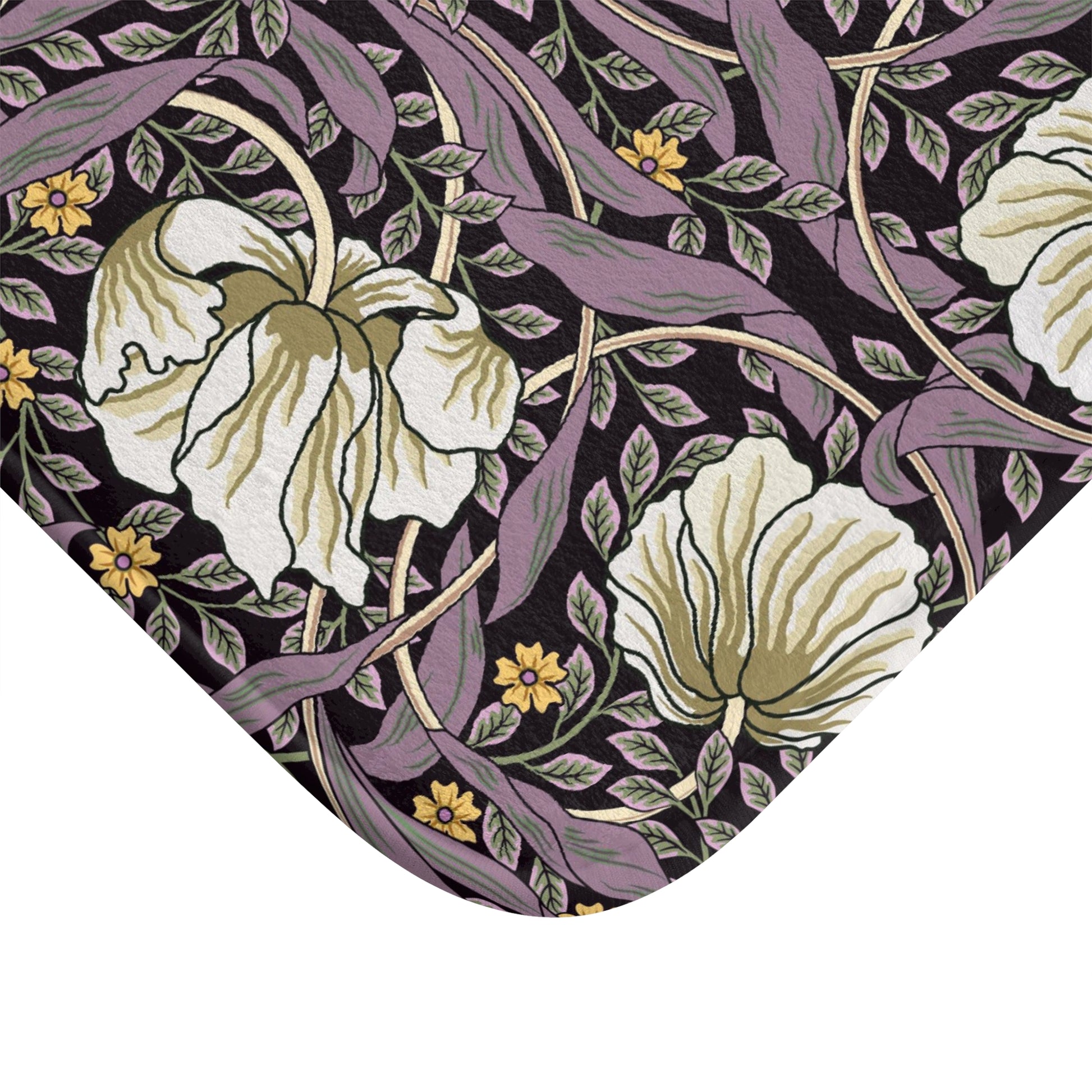 A rectangular microfibre bath mat with a floral pattern inspired by William Morris, predominantly in pink, purple and gold colours.