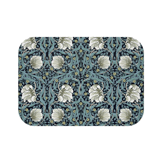 A rectangular microfibre bath mat with a floral pattern in shades of blue and white, inspired by William Morris' design.