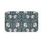 A rectangular microfibre bath mat with a floral pattern in shades of blue and white, inspired by William Morris' design.