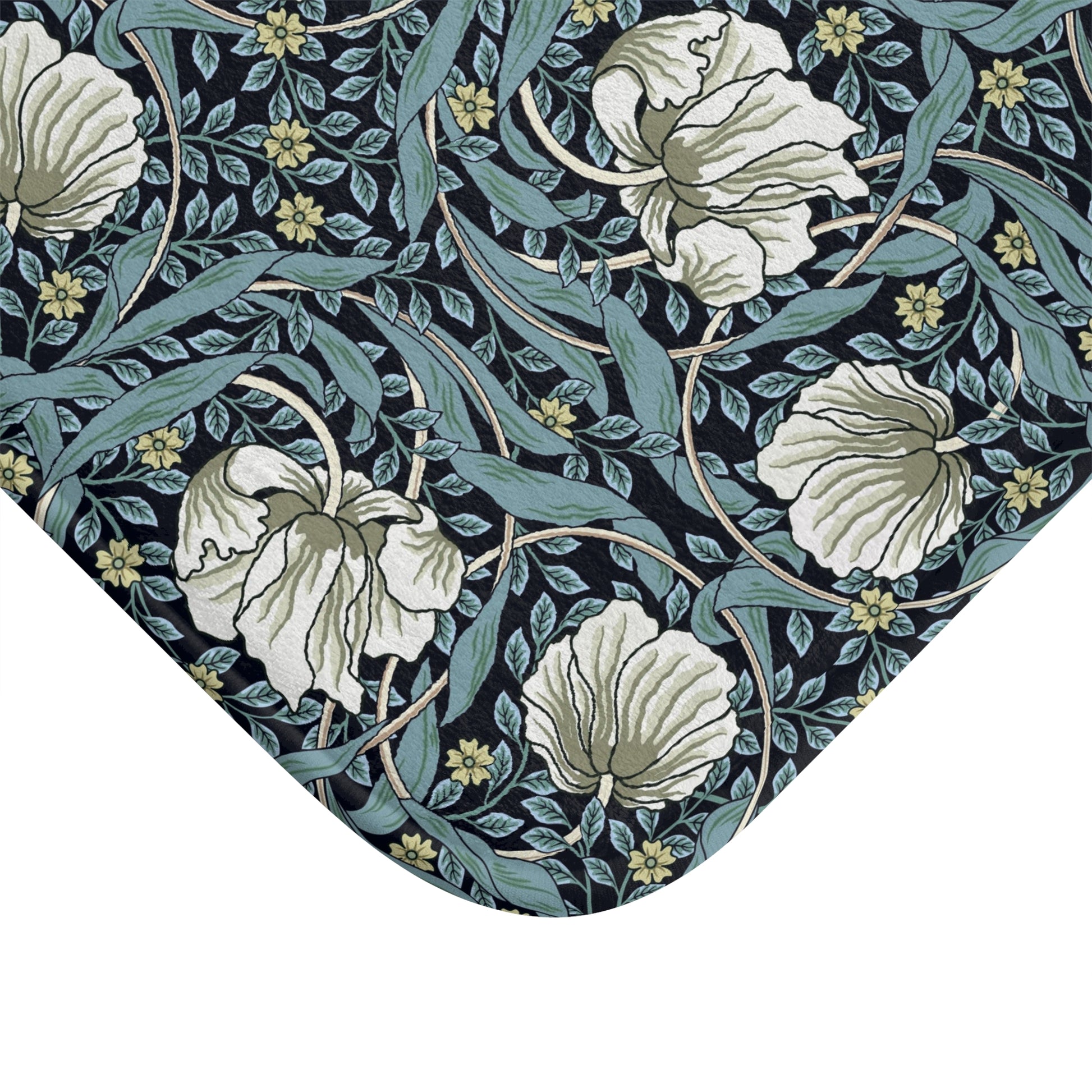 A rectangular microfibre bath mat with a floral pattern in shades of blue and white, inspired by William Morris' design.