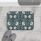 A rectangular microfibre bath mat with a floral pattern in shades of blue and white, inspired by William Morris' design.
