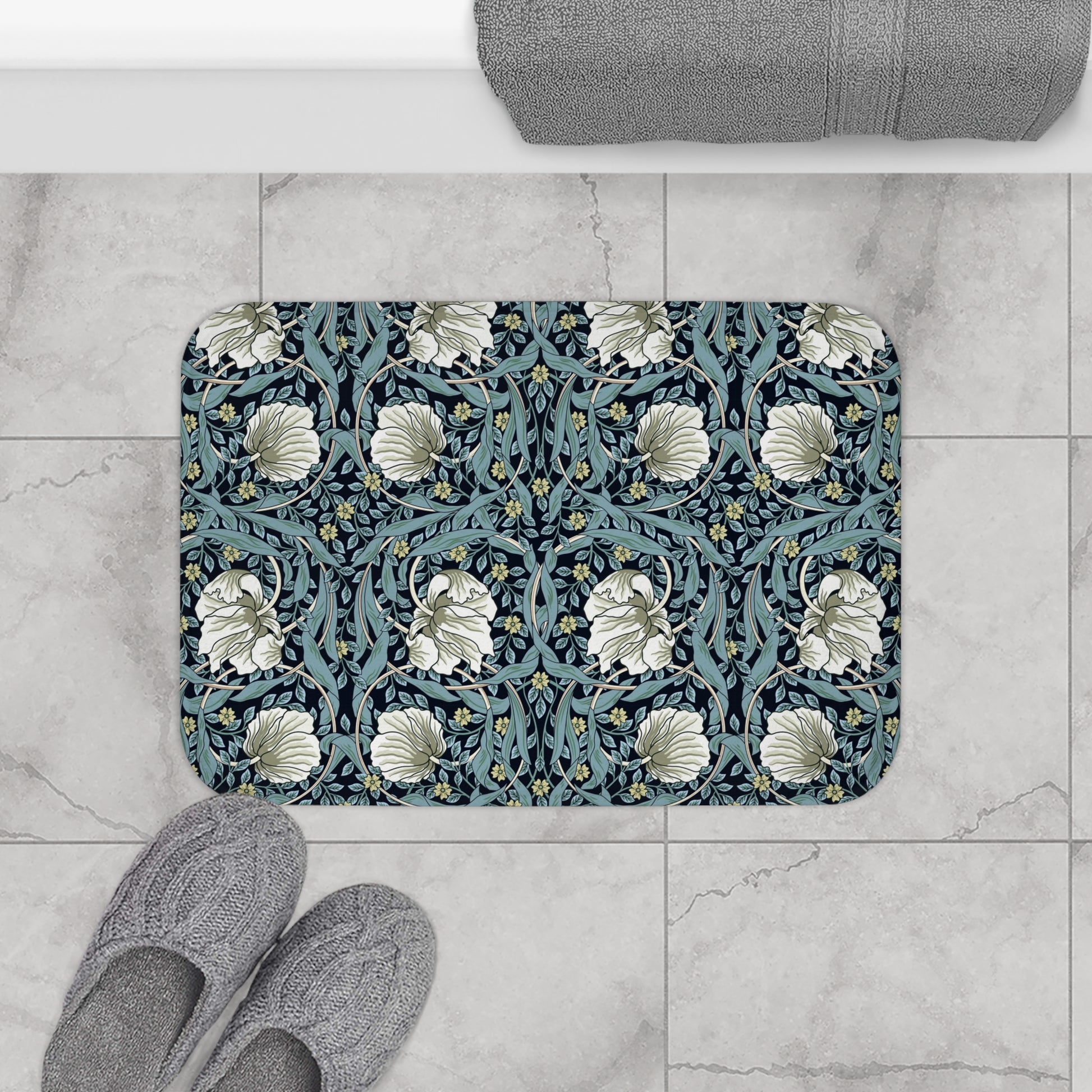 A rectangular microfibre bath mat with a floral pattern in shades of blue and white, inspired by William Morris' design.