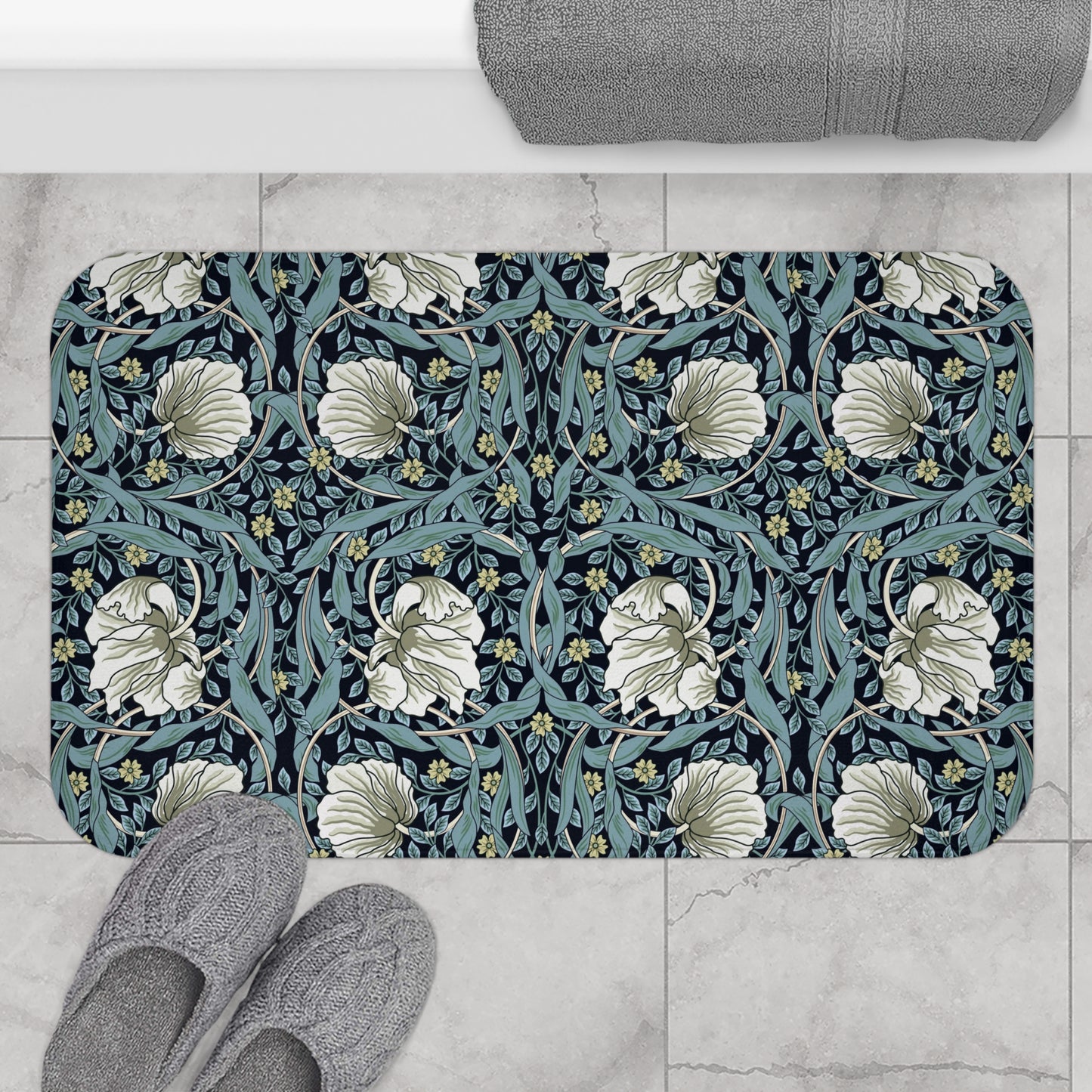 A rectangular microfibre bath mat with a floral pattern in shades of blue and white, inspired by William Morris' design.