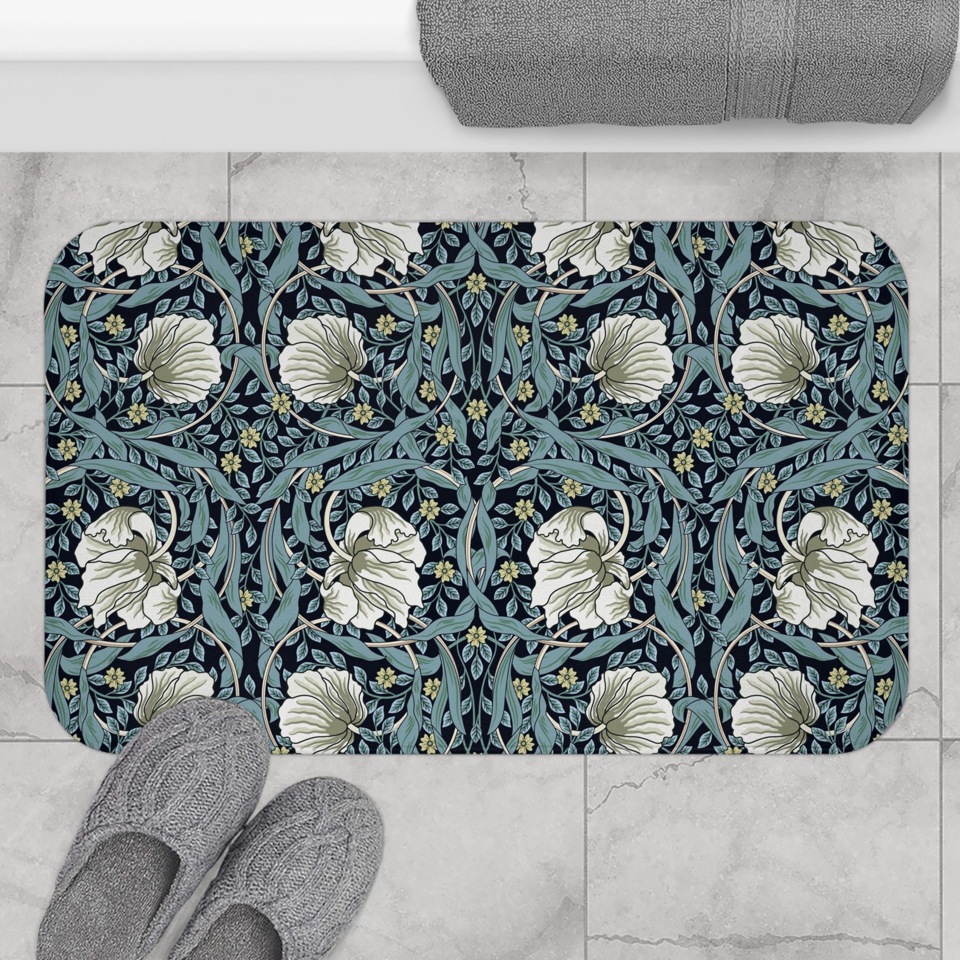 A rectangular microfibre bath mat with a floral pattern in shades of blue and white, inspired by William Morris' design.