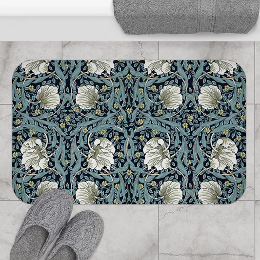 A rectangular microfibre bath mat with a floral pattern in shades of blue and white, inspired by William Morris' design.