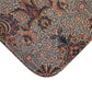 A rectangular microfibre bath mat with a floral pattern inspired by William Morris, in colours predominantly brown and green.