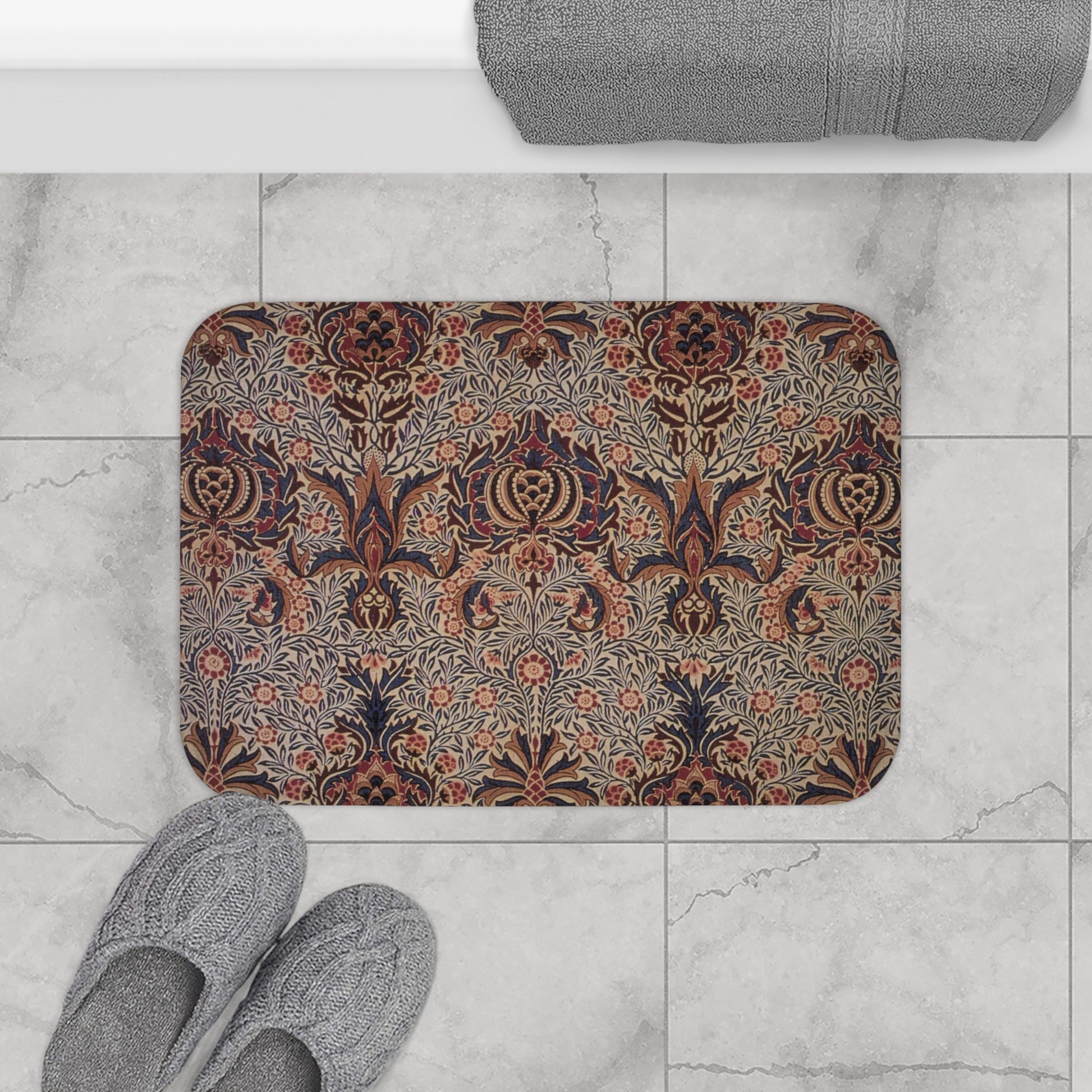A rectangular microfibre bath mat with a floral pattern inspired by William Morris, in colours predominantly brown and green.