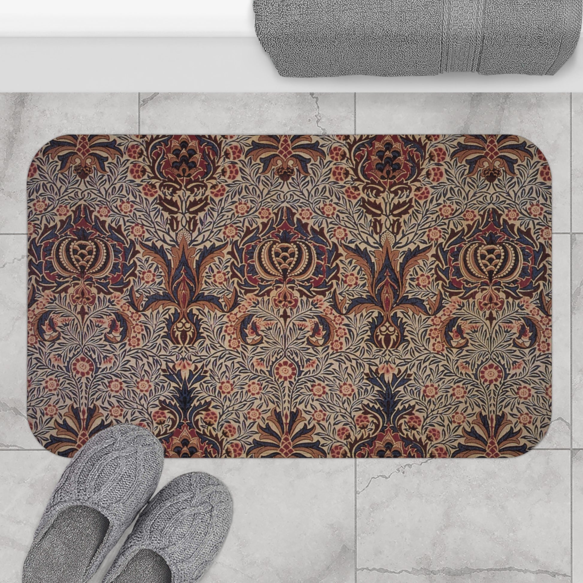 A rectangular microfibre bath mat with a floral pattern inspired by William Morris, in colours predominantly brown and green.