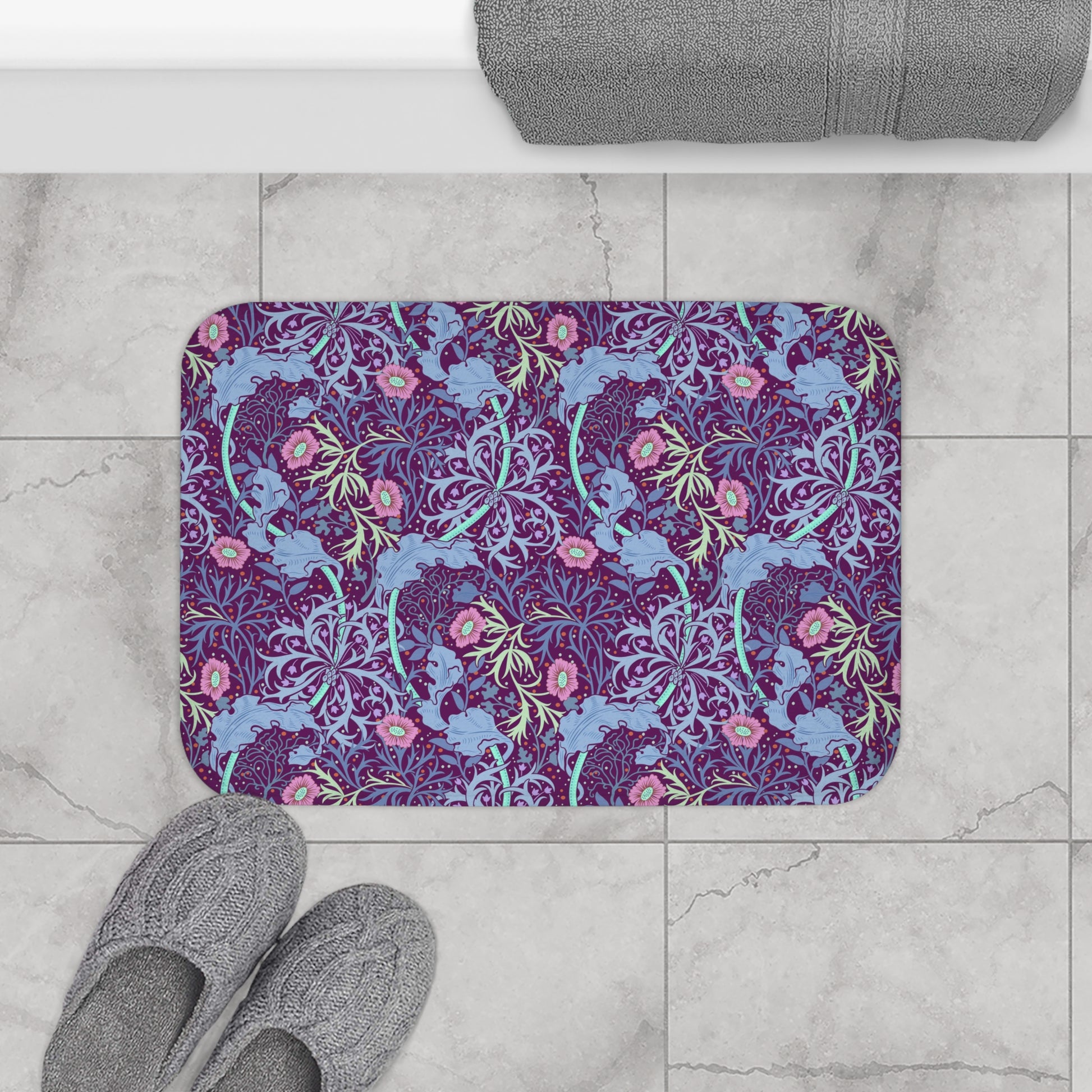 Rectangular microfibre bath mat with a pink flower and seaweed pattern inspired by William Morris.