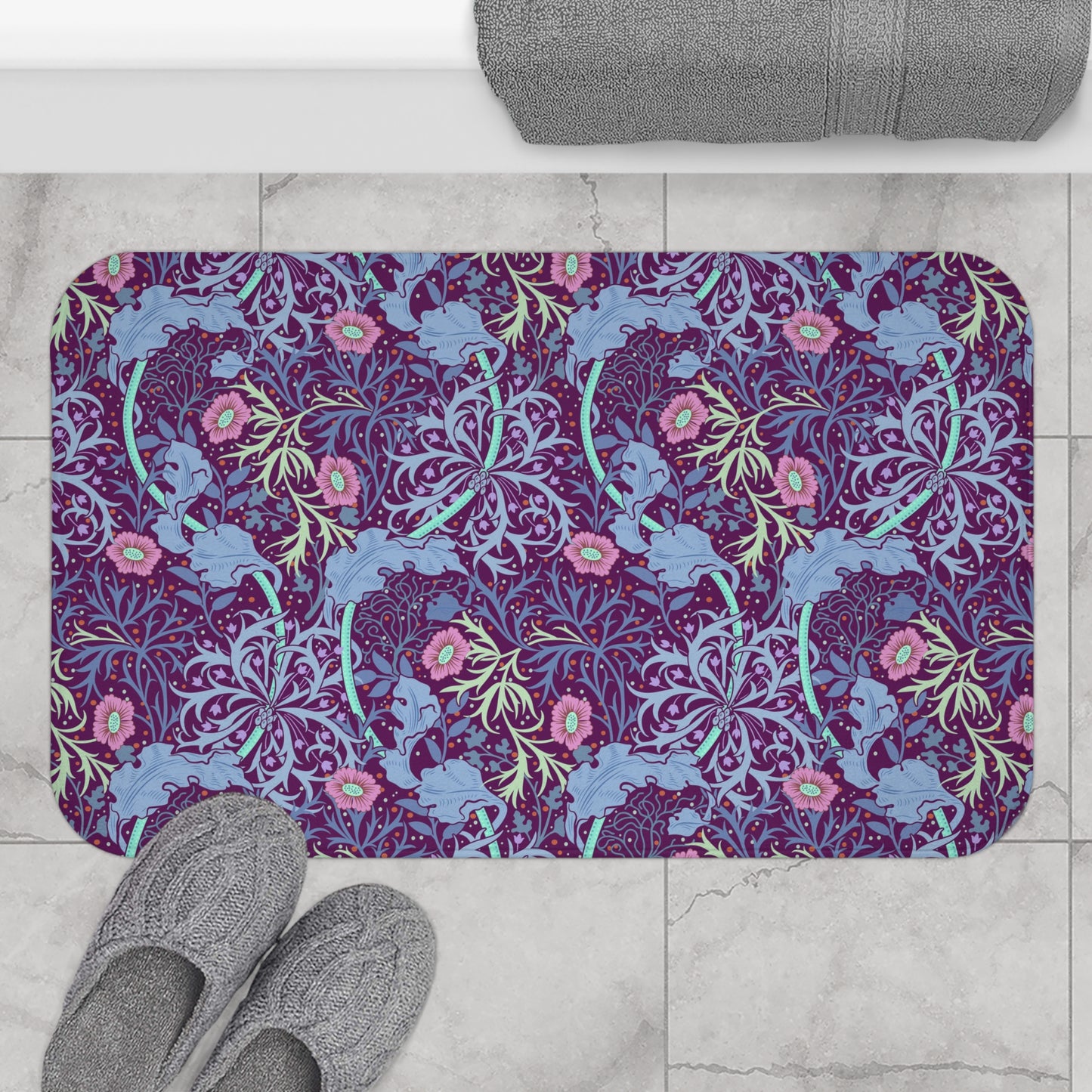 Rectangular microfibre bath mat with a pink flower and seaweed pattern inspired by William Morris.