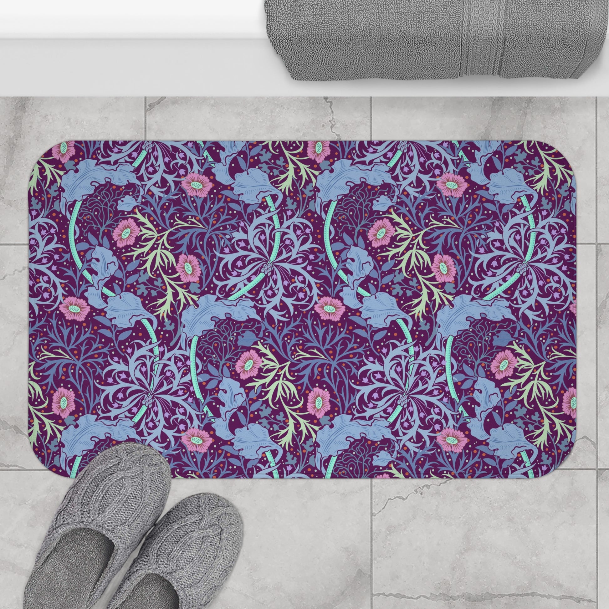 Rectangular microfibre bath mat with a pink flower and seaweed pattern inspired by William Morris.