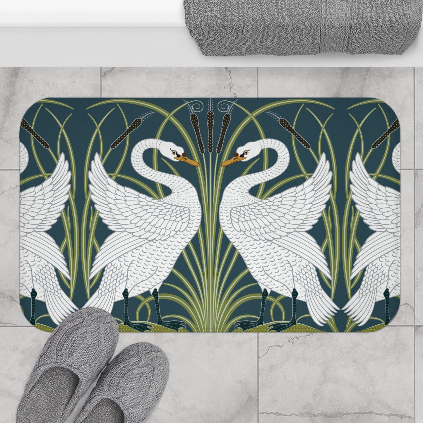 Decorative bath mat with swan design on a tiled floor.