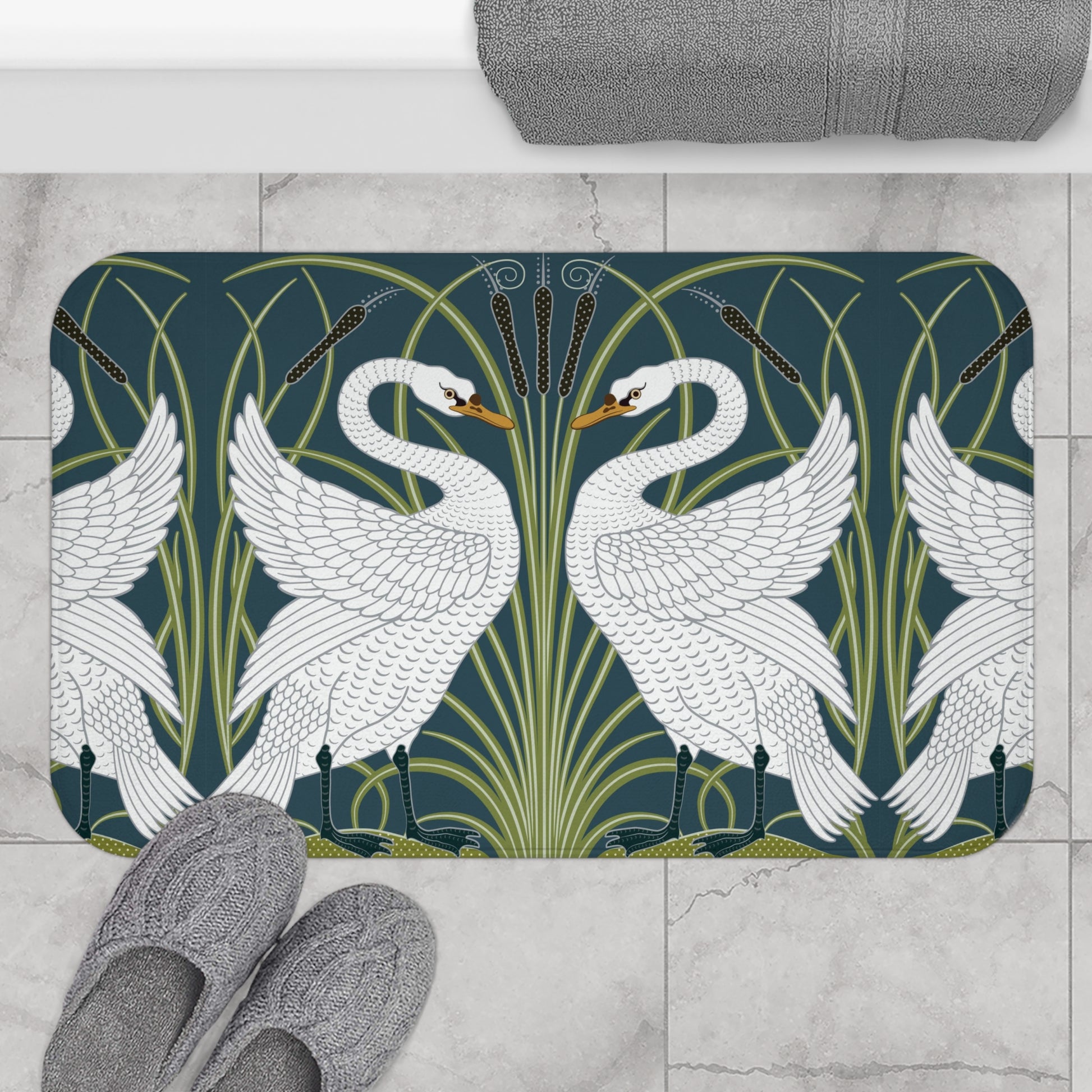 Decorative bath mat with swan design on a tiled floor.